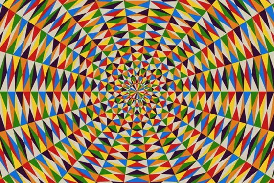 Radiating pattern of triangles arranged in a quadrilateral, with pattern of white, blue, red green, yellow and purple.
